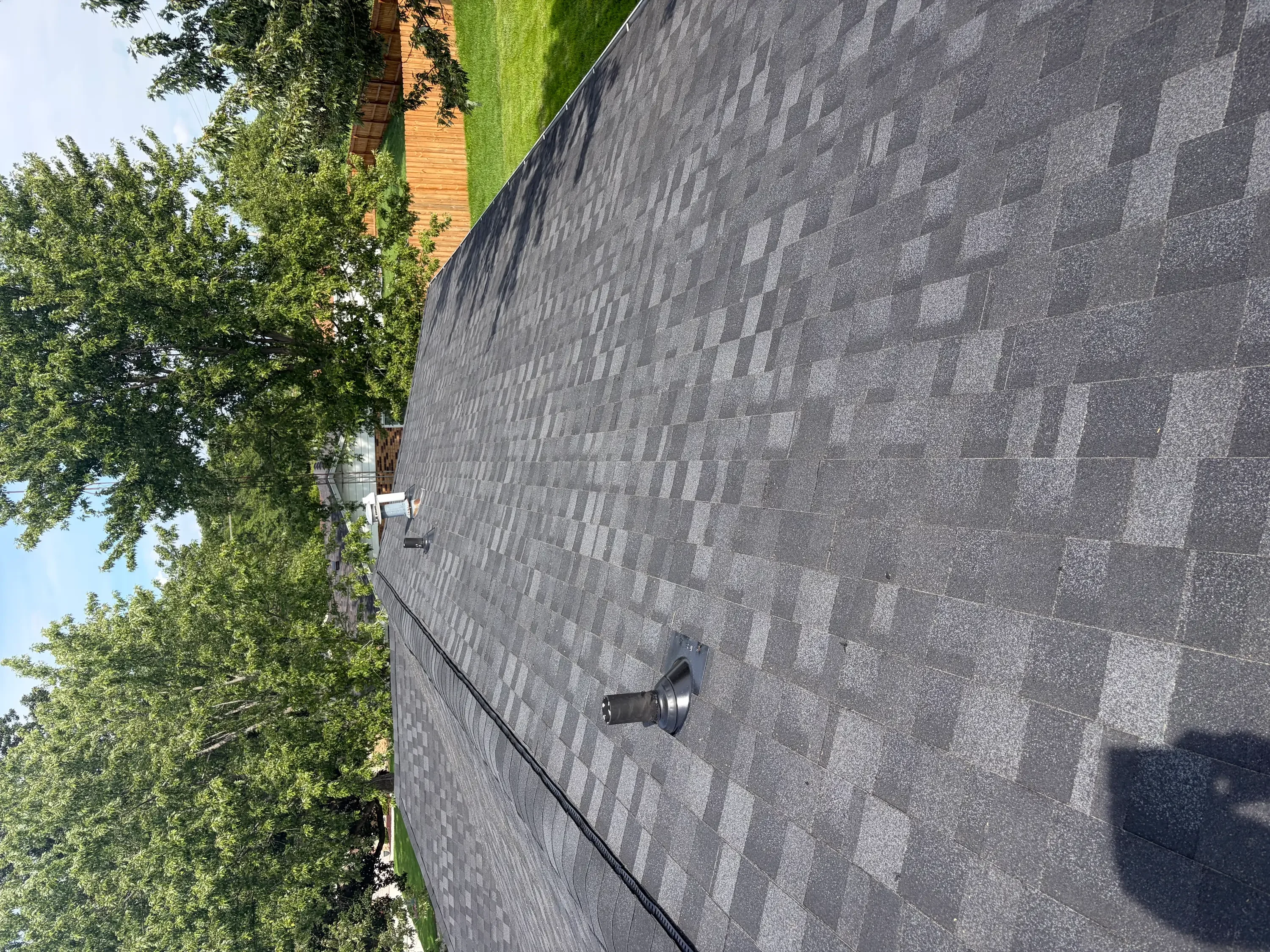 Charcoal gray architectural shingles installed in staggered pattern on residential roof